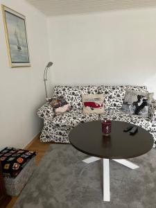 a living room with a table and a couch at Skönaste stället som finns. Bara 300 m till havet. in Lysekil