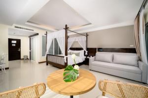 a living room with a couch and a table at Railay Princess Resort & Spa in Railay Beach