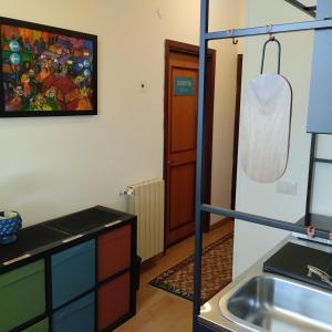 a kitchen with a sink and a counter top at Garden House Alla Torre in Isola delle Femmine