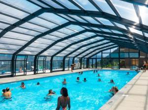 a group of people in a swimming pool at Les Iris T2 station Alpe Huez in Auris