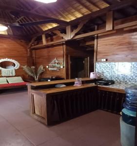 a kitchen with a counter in a room at Jembrana Bali Homestay in Pengambengan
