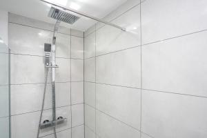a shower with a shower head in a bathroom at Lucas in Sudbury