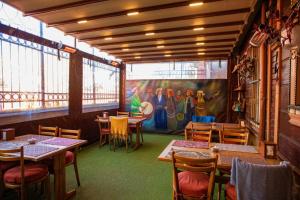 a restaurant with tables and chairs and a painting on the wall at April Hotel in Istanbul