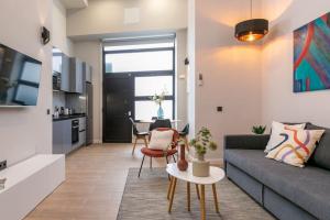 a living room with a couch and a table at Beautiful duplex in front of Vista Alegre Palace in Madrid