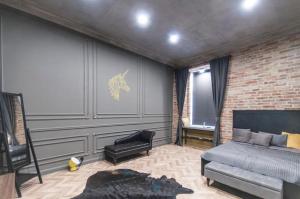 a bedroom with a bed and a brick wall at Geometric Luxury Apartment in the center with 3BR in Budapest +32 photos