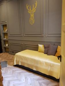 a bed in a room with a wall with a deer on it at Geometric Luxury Apartment in the center with 3BR in Budapest