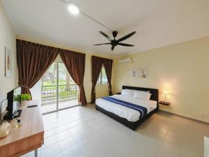 a bedroom with a bed and a ceiling fan at Desaru Black Beach Sky Mirror Resort in Desaru