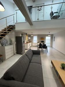 a large living room with a couch and a kitchen at La maison du bonheur 70 m² in Saint-Amand-les-Eaux +27 photos