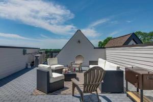 a patio with chairs and a couch and a table at Twin Homes of Art & Rooftops, Free Night Promo! in Nashville