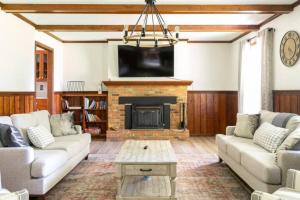 a living room with a couch and a fireplace at Whole House 85 Acre Private Ranch Sleeps 8, hot-tub king beds in Logan