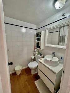 a white bathroom with a toilet and a sink at Habitación en Madrid in Madrid