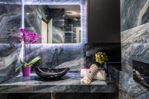 a bathroom with a sink and a mirror at Elegant, Spacious and hitech apt at Koukaki in Athens
