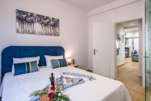 a large bed with a blue headboard in a bedroom at Elegant, Spacious and hitech apt at Koukaki in Athens