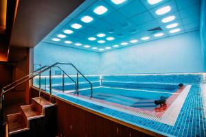 a large swimming pool with a staircase in a building at Eduard Elegance Studio 1 in Bucharest