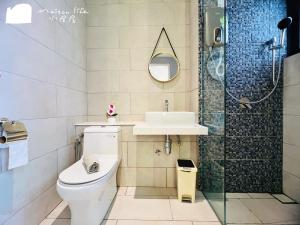 a bathroom with a toilet and a sink and a shower at The Shore Maison Life 小居屋 in Kota Kinabalu