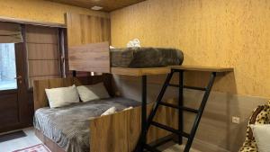 a bunk bed in a room with a bed in a room at cozy apartments kazbegi in Stepantsminda