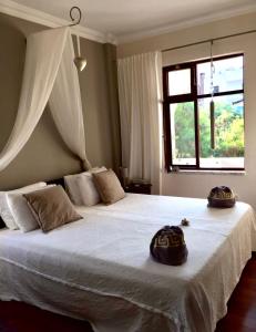 a bedroom with a large bed with two hats on it at Boutique Hotel Akvilla in Sarigerme
