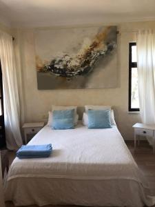 a bedroom with a large bed with blue pillows at Boutique Hotel Akvilla in Sarigerme