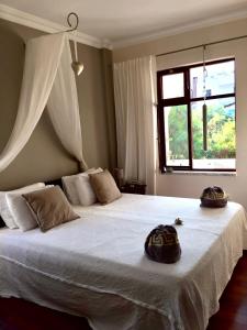 a bedroom with a large white bed with a window at Boutique Hotel Akvilla in Sarigerme