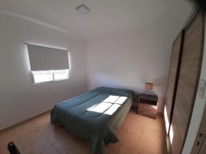a small bedroom with a bed and a window at La Cañada in Juana Koslay 
