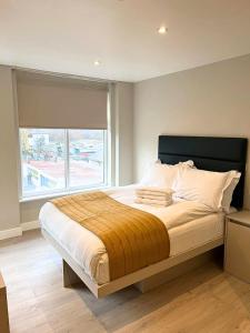 a bedroom with a large bed with a window at Hendon Studios in The Hyde