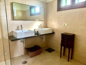 a bathroom with two sinks and a mirror at Luxury Villa Sea Front -La Orilla in Playa Honda