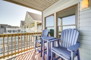 two blue chairs sitting on a porch at Kill Devil Hills Condo with Beach Access On-Site! in Kill Devil Hills