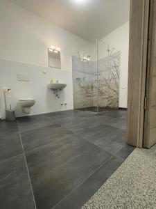 a bathroom with a toilet and a sink at GPHotel/Boardinghaus in Leverkusen