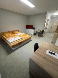 a bedroom with a bed and a desk and a table at GPHotel/Boardinghaus in Leverkusen