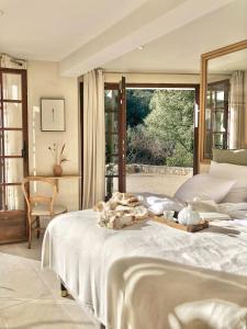 ein Schlafzimmer mit einem Bett und einem großen Fenster in der Unterkunft Mas de Kyoto, Maison d'hôtes l'expérience Japonaise in Dions