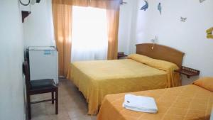 a hotel room with two beds and a window at Hotel Brisas Marinas in San Clemente del Tuyú +107 photos
