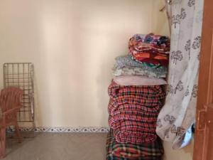 a pile of clothes sitting next to a wall at Om Laxmi Narayan Homestay in Diveagar