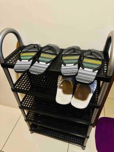 a black shelf with shoes and shoes on it at Horizons 101- at Heart of Cebu in Cebu City