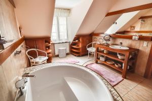 a bathroom with a large tub and a sink at Willa nad Popradem in Piwniczna-Zdrój