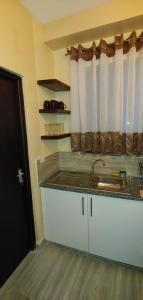 a kitchen with a sink and a counter top at Homes By Sandra in Kilifi