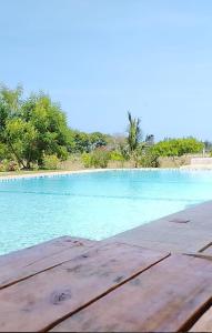 a pool of blue water with trees in the background at Homes By Sandra in Kilifi