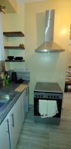 a kitchen with a stove with a towel on it at Homes By Sandra in Kilifi