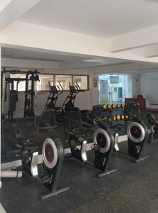a gym with a row of exercise bikes in a room at Lovella Suites Gold Park in Nairobi