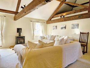a bedroom with a white bed and a fireplace at The Old Sail Loft - Emsworth in Emsworth