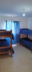 a room with two bunk beds and a window at Casa de Campo in Tanti