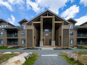an exterior view of a large building with large windows at Verbier 1-103 / Vast & Luxurious 3 bedroom in Mont-Tremblant