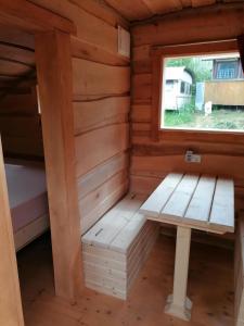 à l'intérieur d'une cabane en rondins avec un banc dans l'établissement Wolpertinger | Camping-Aach, à Oberstaufen