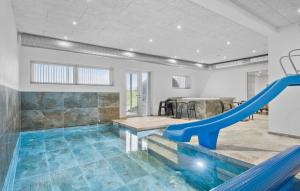 - une piscine intérieure avec toboggan dans une maison dans l'établissement Stunning Home In Lgstrup With Kitchen, à Løgstrup