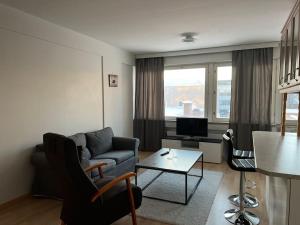 a living room with a couch and a table at Apartment Kopin2 in Kokkola
