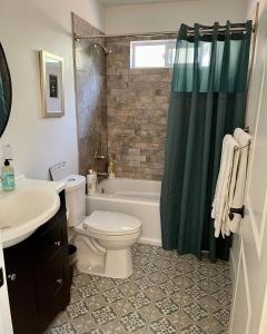 a bathroom with a toilet and a tub and a sink at Avenue of the Giants Pepperwood Place (#2) in Miranda +30 photos