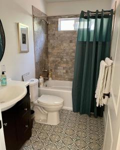 a bathroom with a toilet and a tub and a sink at Avenue of the Giants Pepperwood Place (#2) 