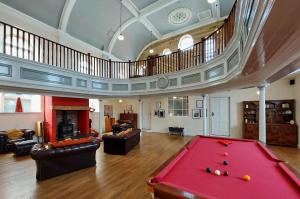 a large living room with a red pool table at Ty Capel in Tywyn in Tywyn