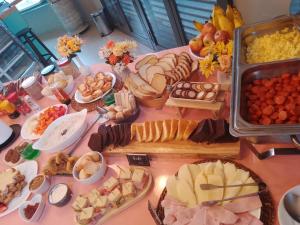 a table topped with lots of different types of food at Hotel Centro 433 in São Paulo