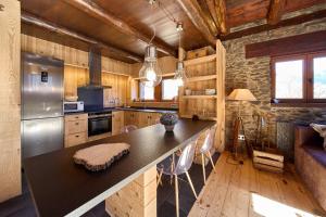 a kitchen with a large island in a room at Borda Climent in Canillo
