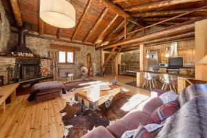 a living room with a couch and a fireplace at Borda Climent in Canillo